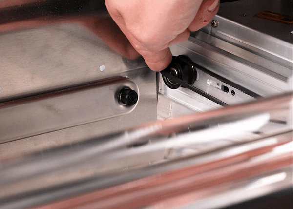 Animated gif of spinning the idler pulley to help the belt roll onto the pulley