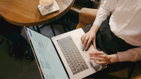 This image shows a woman typing on laptop​​  