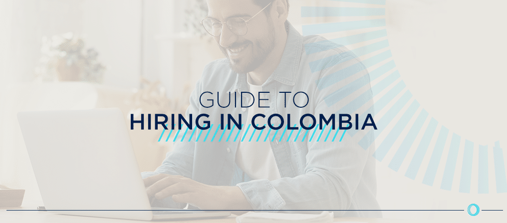 Smiling man wearing glasses working at a laptop