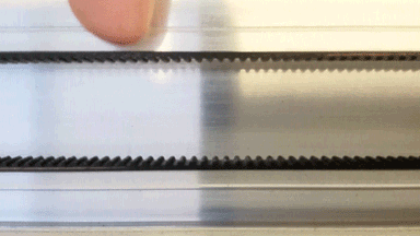 Animated image of a finger pushing on the carriage plate belt. Only the side being pushed moves